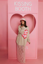 Krista blowing a kiss in front of the kissing booth.