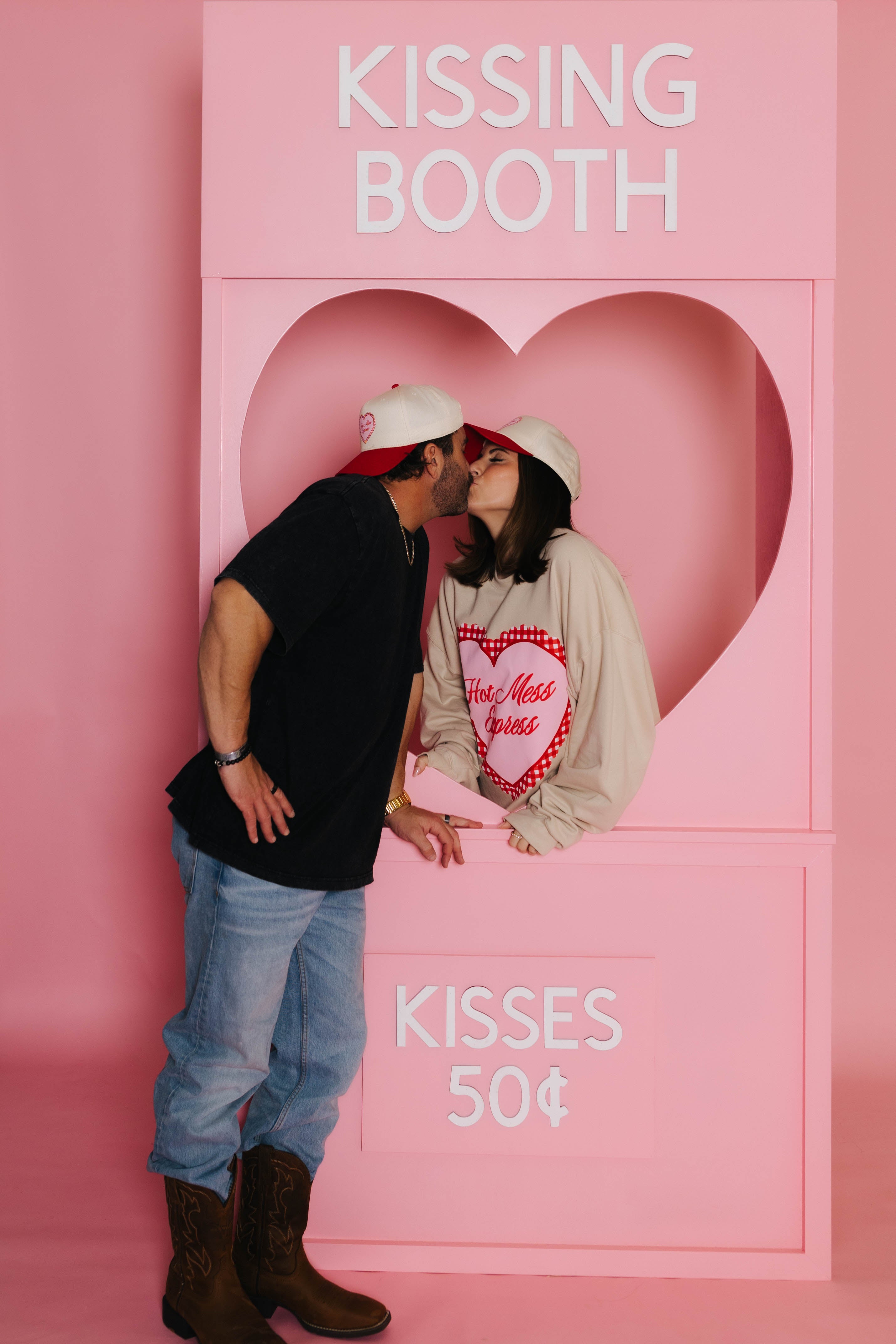 Bryce and Krista kissing in the kissing booth