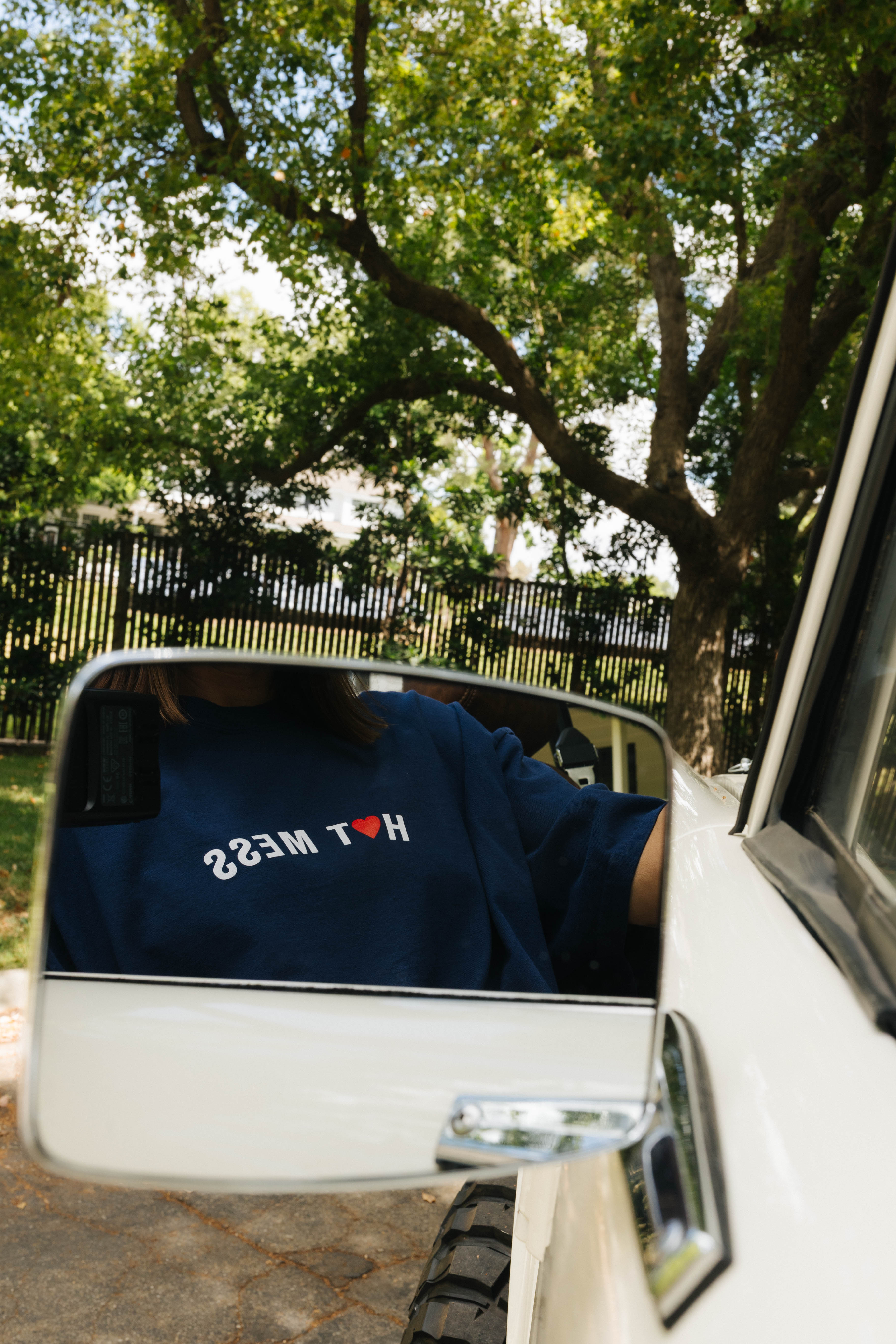 Hot Mess seen through the mirror on the car