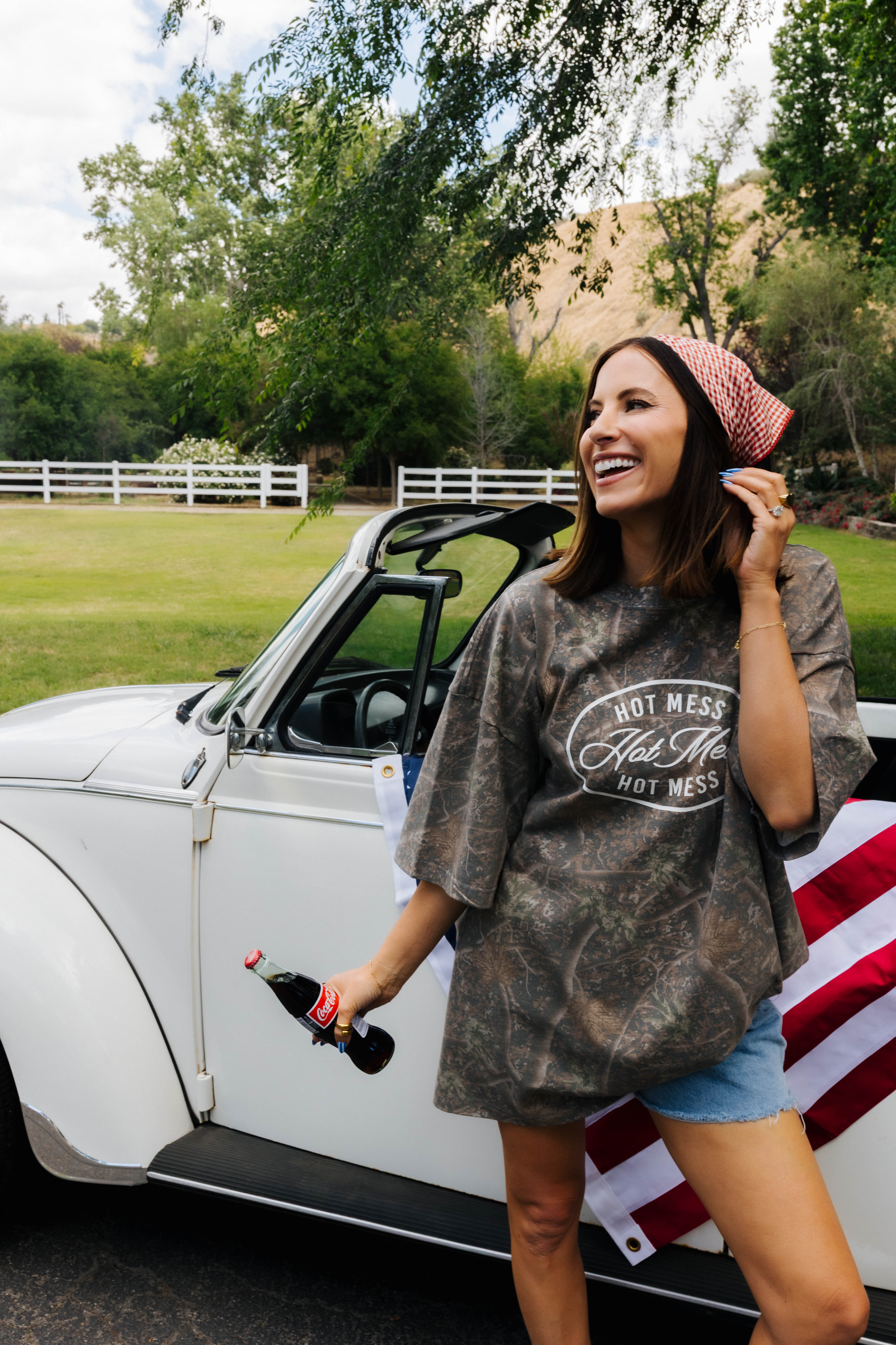 Krista posing with a coke bottle in front of the vw bug 