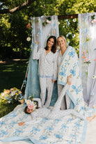Krista and her mo with the blanket around them and kolly in the ground
