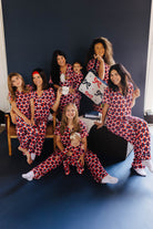 group of mom and kids posing in matching gingham pjs 