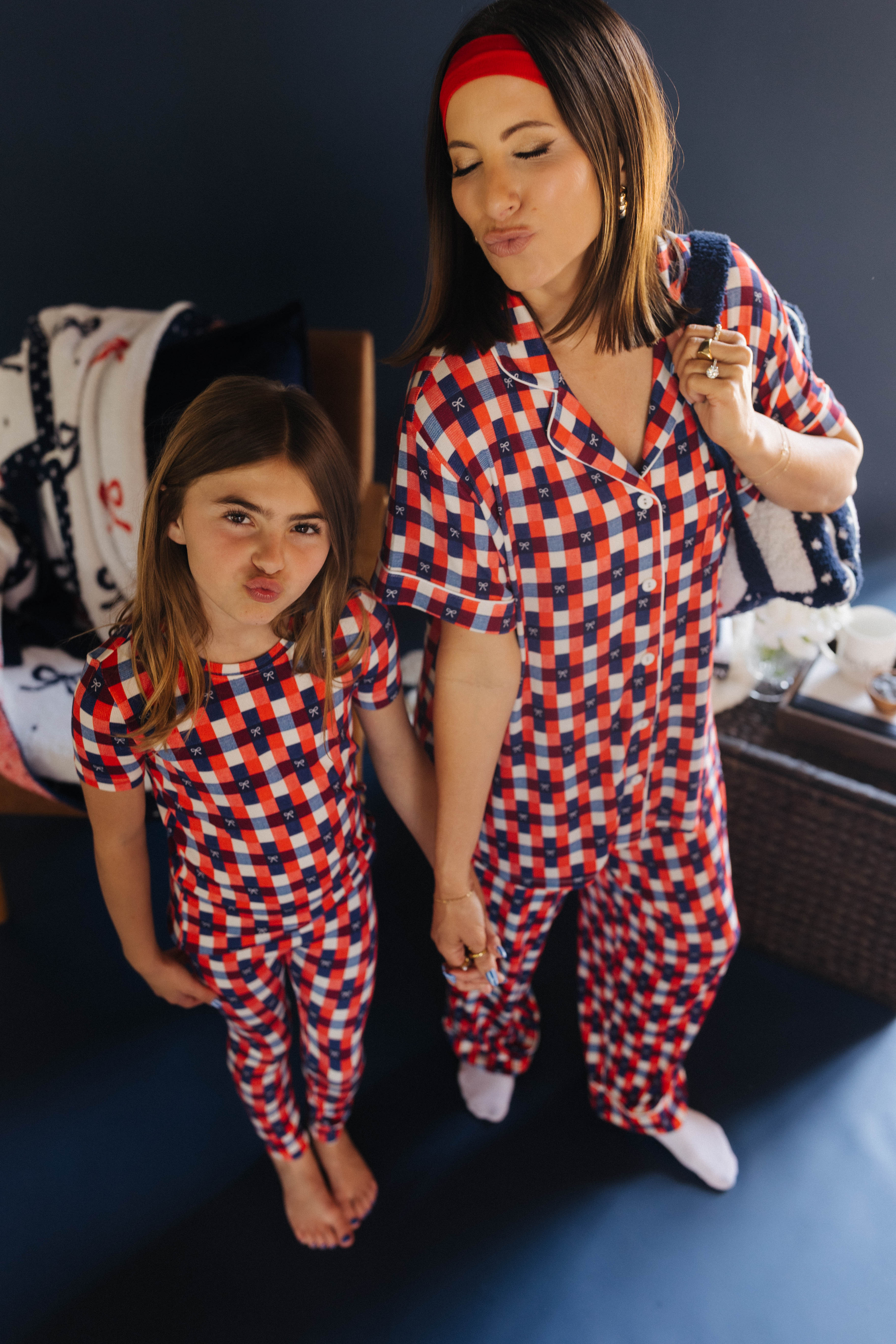 mom and daughter posing in matching pjs making kissy face