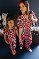 mom and daughter posing in matching pjs making kissy face
