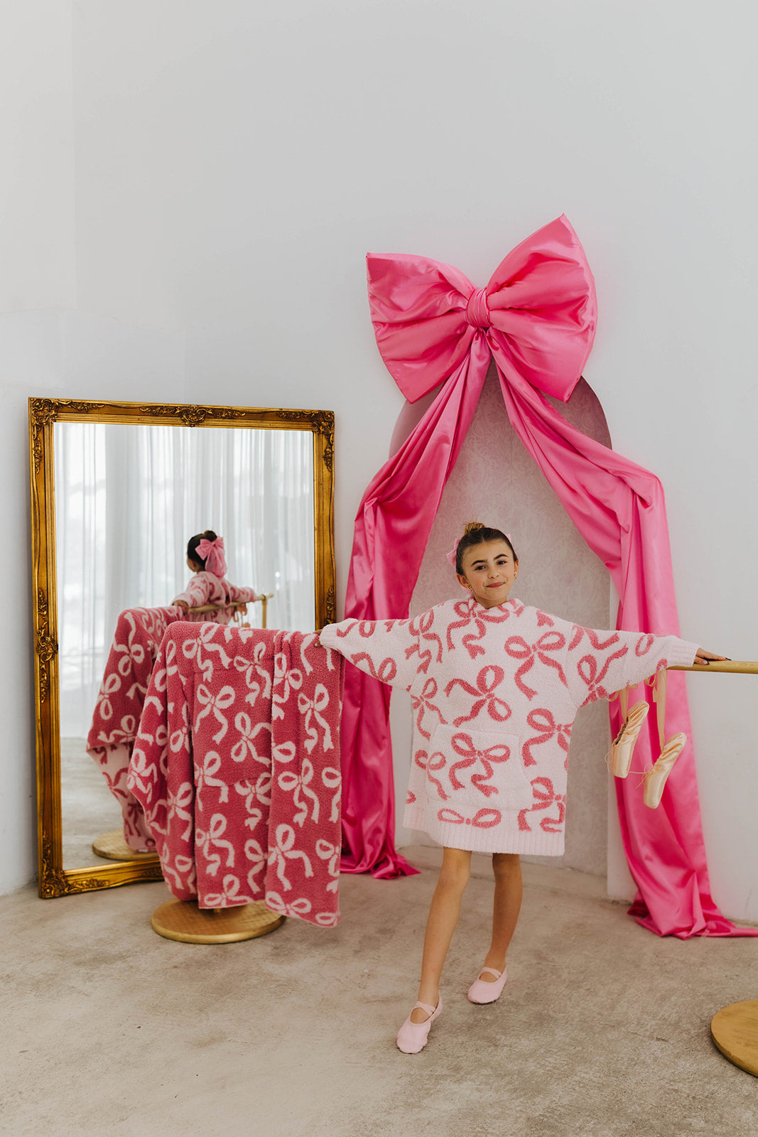 Woman wearing a dress with pink ribbon patterns in a room 