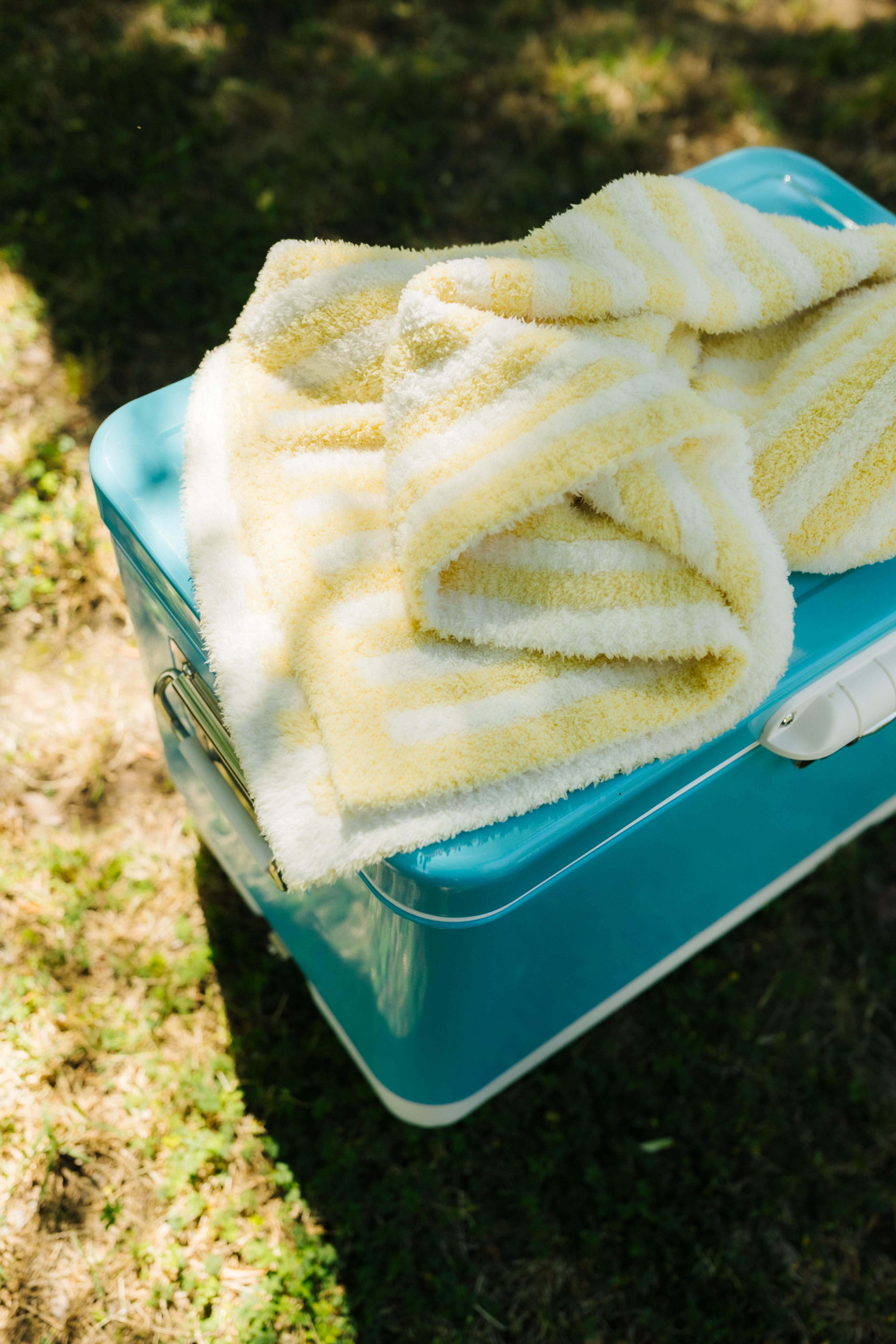 folded baby blanket on blue cooler