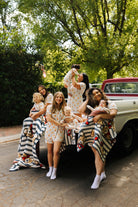 women and their kids in the back of a truck in teddy pjs wrapped in teddy blankets
