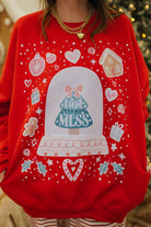 Red sweater with a snow globe design and 'Hot Mess' text, worn by a person.