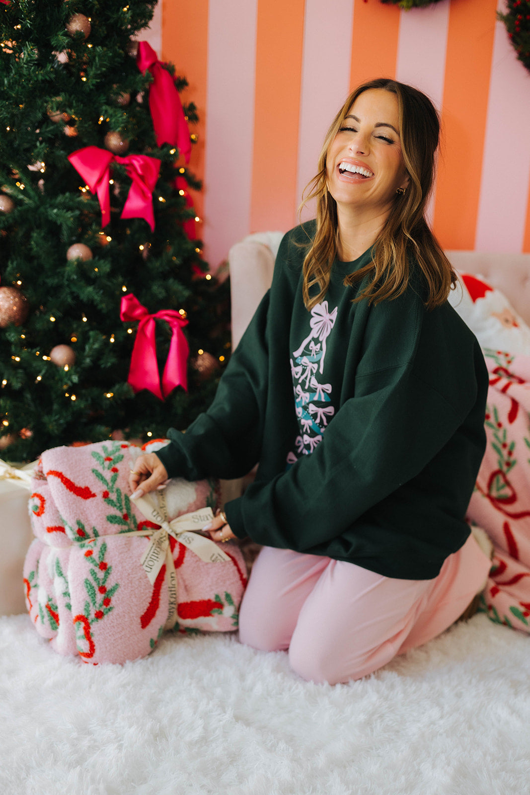 Woman in festive setting with Christmas tree and presents