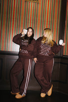 Models showing the front and back of the Fall Bucket List sweatshirt