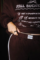 Waistband label detail on brown sweatpants