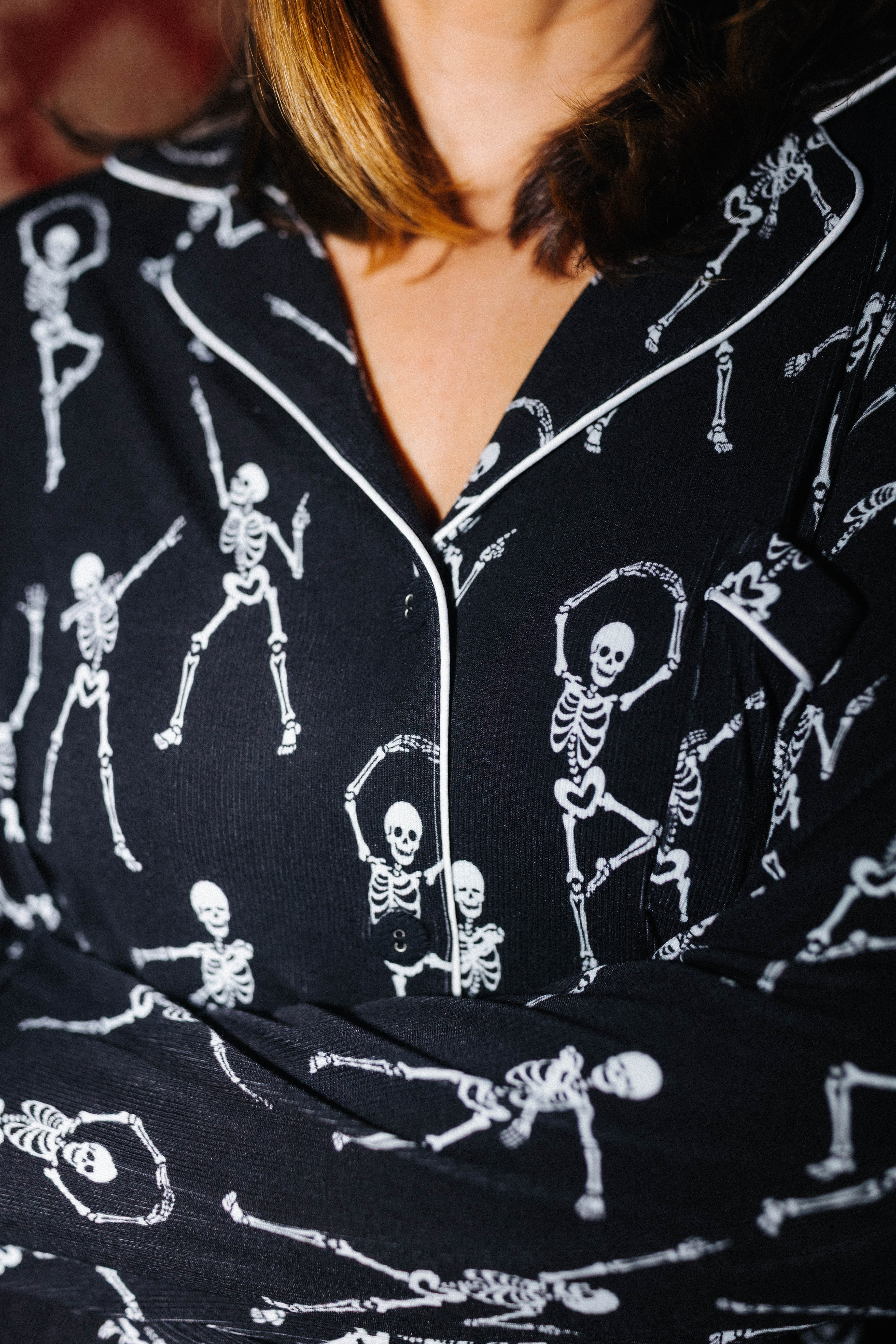 Close view of the collar and skeleton print on adult Skelly pajamas