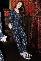 Front view of adult Skelly long pajamas