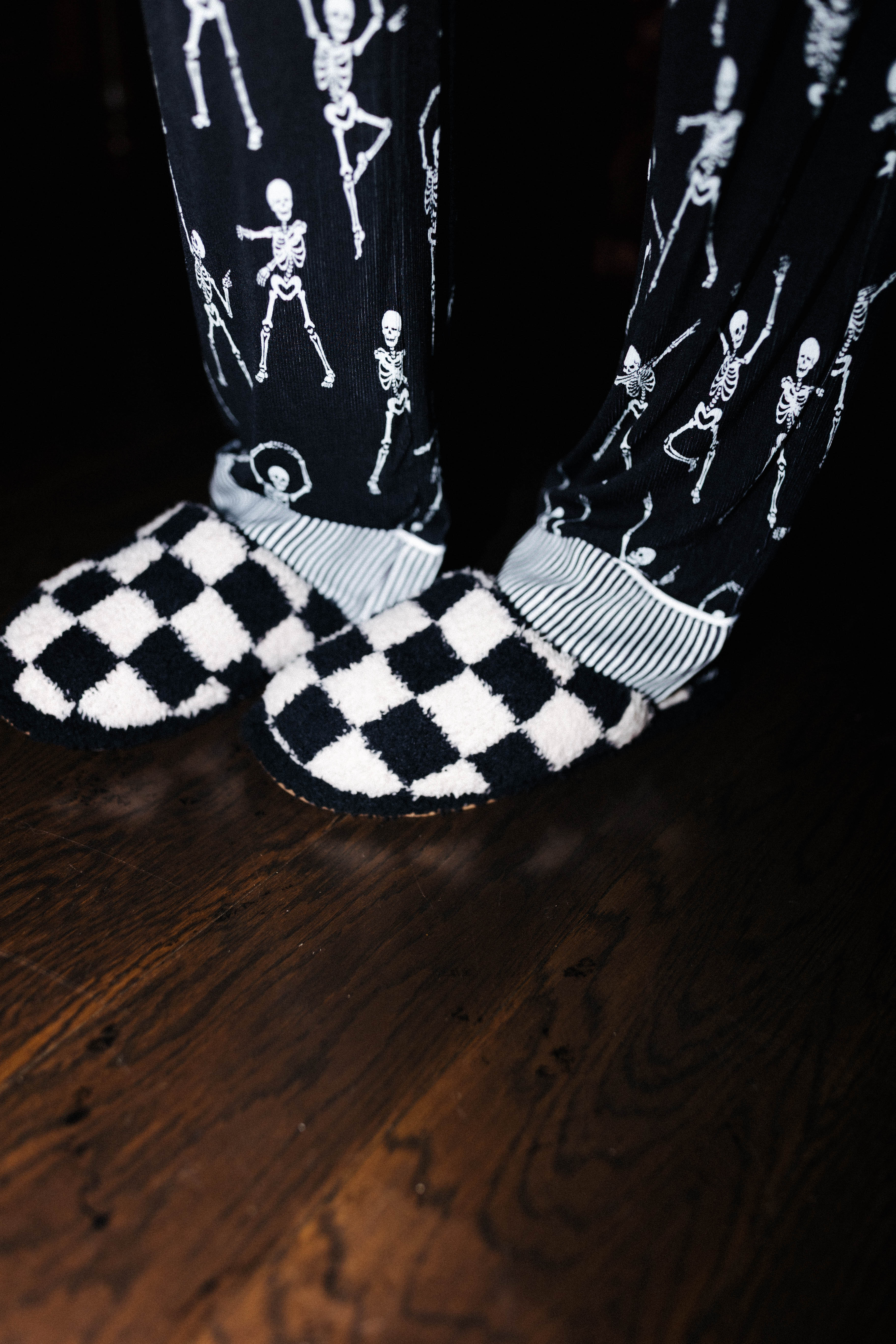Sand and black check slippers worn with Skelly pajamas