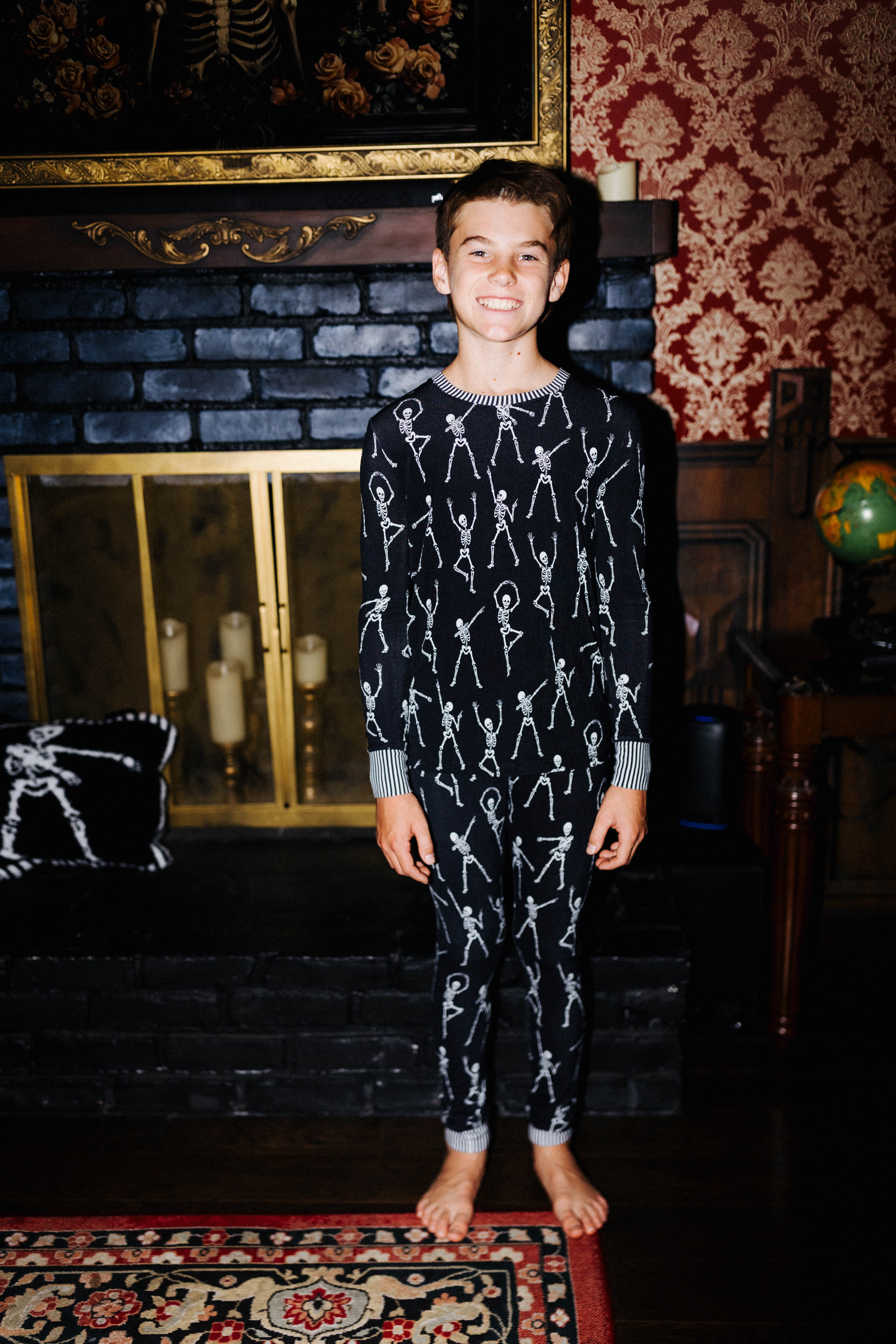 Front view of kids Skelly long pajamas on an older child