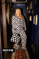Ensley in XXL pajamas smiling holding a quillow
