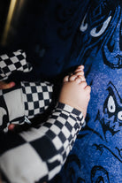 A close-up lifestyle shot of a baby's feet in the pjs 