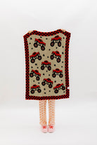 front of monster truck blanket showing the red and black monster trucks and black stars