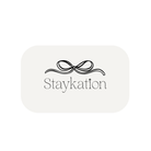 Rectangular white object with 'Staykation' text and decorative bow design on a white background