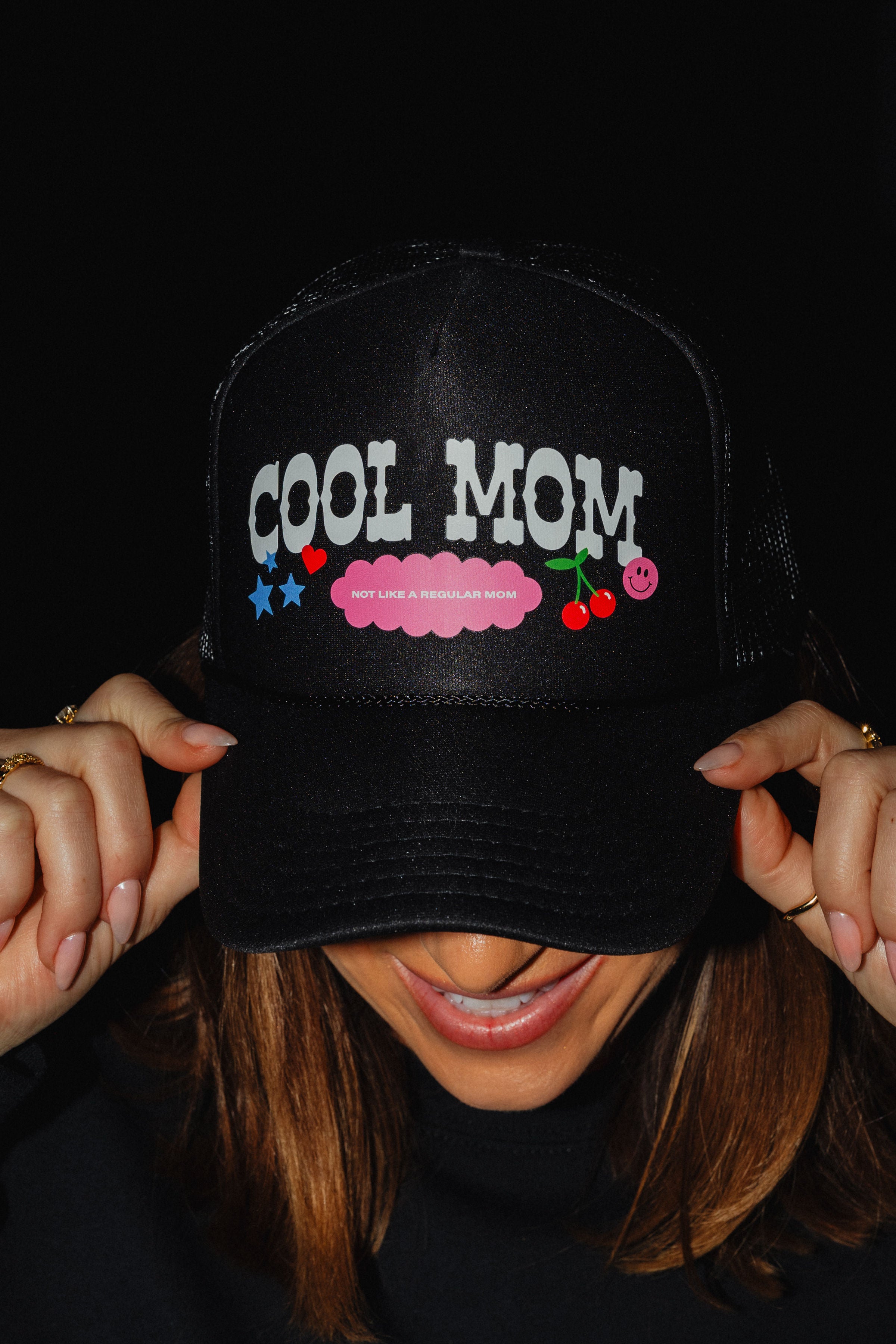 Cool mom hat with text saying not like a regular mom with cherry and smiley face
