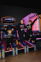 Krista Boss and Kamp jumping in the air off of the arcade game