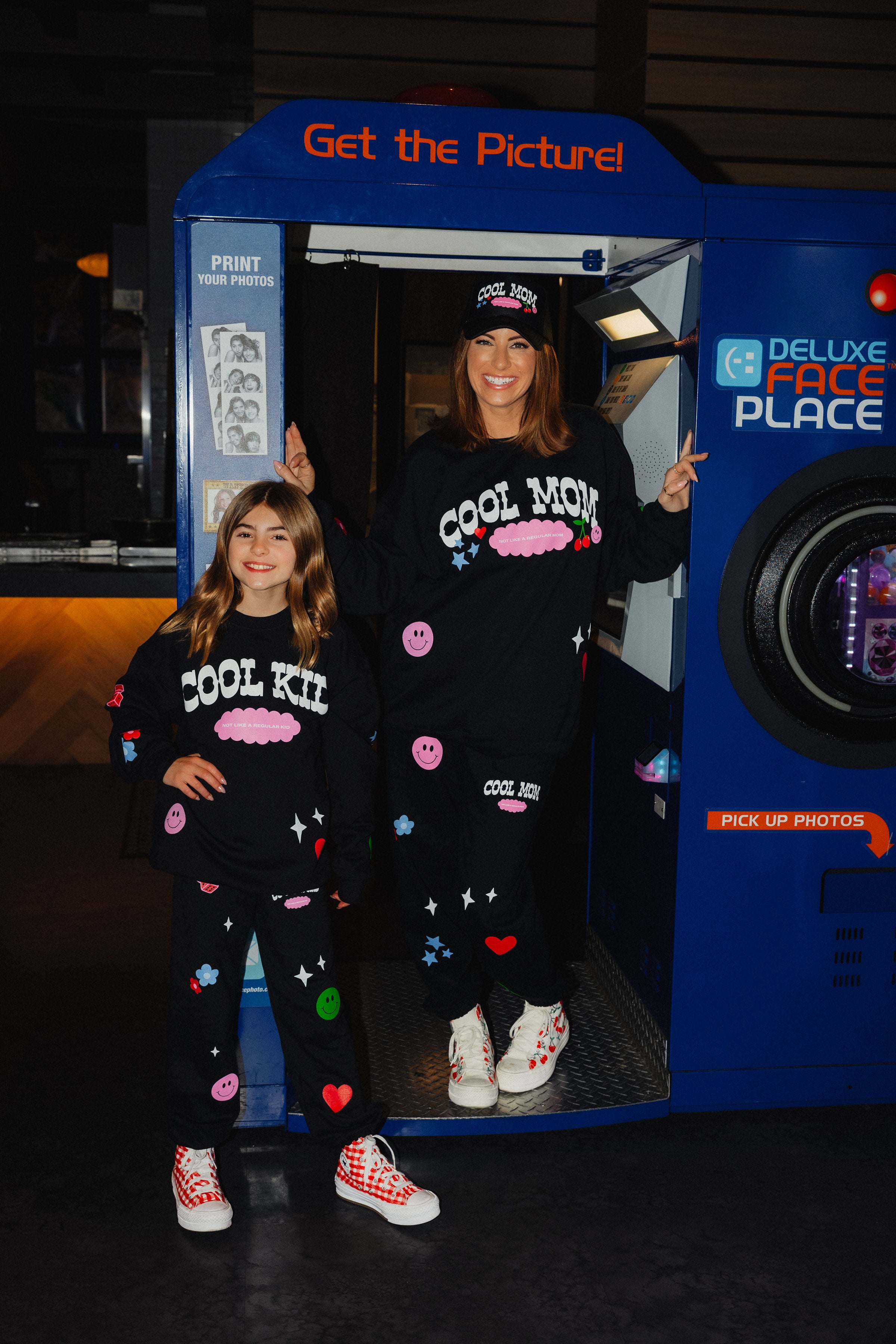 Krista and kolly posing in front of the photobooth